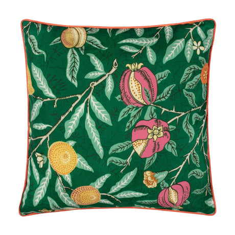 Square polyester cushion in Fruits print, deep pink pomegranates and golden fruit among green leaves on a forest green ground, with coral-orange piped trim, shown on a white background.
