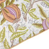 Close-up of the Fruits Piped Polyester Cushion in Lemon/Lime, showing a pomegranate and citrus fruit print on cream fabric with green leaves and a piped yellow edge trim.