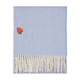 Fruits Knitted Polyester Throw in chambray blue with an embroidered red strawberry motif and cream fringe tassels, shown on a plain white background.