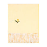 Fruits Knitted Polyester Throw in Zesty Lemon, a folded pale yellow throw with an embroidered lemon motif and white tasselled fringe, shown on a plain white background.
