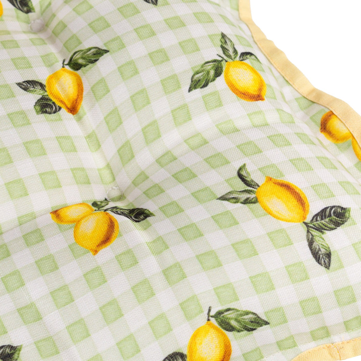 Close-up of a Fruits Gingham polyester placemat in sage, showing a hand-painted lemon and leaf print over a green and cream check with a yellow trim edge.