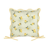 Square seat pad in sage-and-white gingham check with lemon and leaf print, scalloped edge, yellow piping and fabric ties, shown on a plain white background.