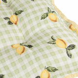 Close-up of the Fruits Gingham Polyester Seat Pad in sage, showing a green-and-white check pattern with lemon and leaf print, scalloped edge, and yellow contrast piping.