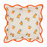 Square polyester cushion with a scattered orange print and green leaves on cream and yellow striped fabric, edged with a wavy orange piped border, shown on a white background.