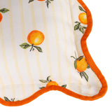 Close-up of the Fruits Striped Polyester Cushion in yellow, showing hand-painted orange fruit motifs with leaves on cream and yellow striped fabric, edged with a scalloped orange piped trim.
