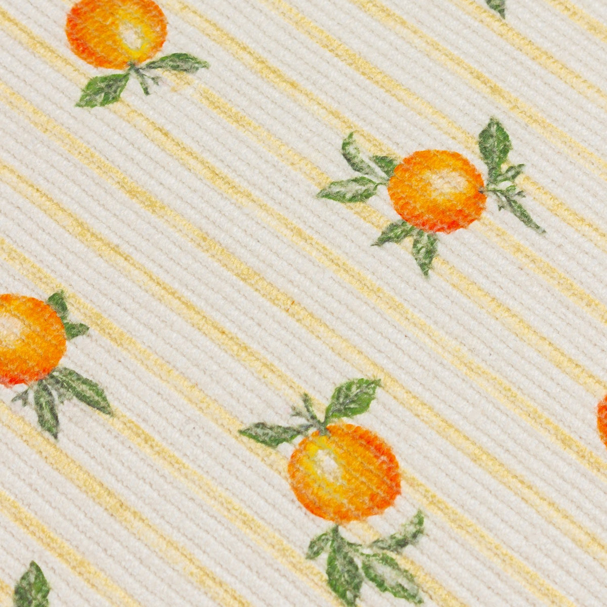 Close-up of the Fruits Striped Polyester Table Runner in yellow, showing orange citrus fruits with green leaves on cream fabric with fine yellow stripes.