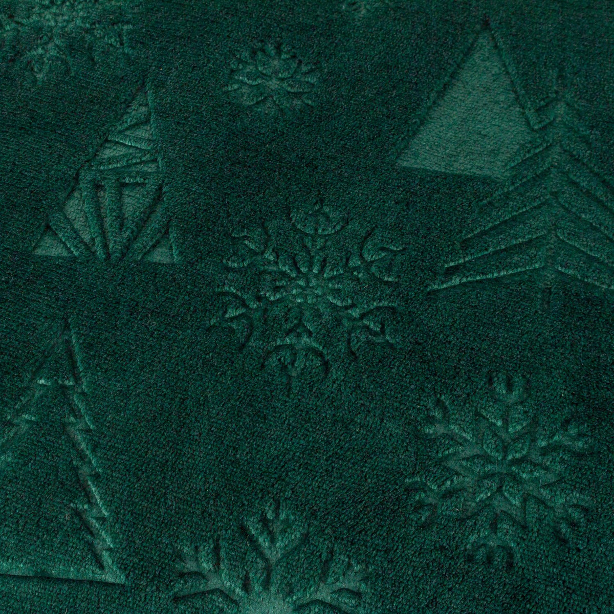 Festive Time Sherpa Woodland Polyester Throw in emerald green, close-up of the soft fleece front with embossed trees and snowflakes in a tonal, low-relief pattern.