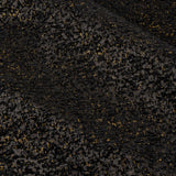 Close-up of Galaxy chenille eyelet curtain fabric in black, showing a soft textured weave flecked with gold metallic highlights.