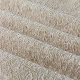 Close-up of Galaxy chenille eyelet curtain fabric in blush, showing a flecked pale pink and cream weave with fine gold threads and soft folds.