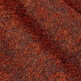 Close-up of Galaxy chenille eyelet curtain fabric in copper, showing a textured rust and dark base weave with glinting golden flecks.