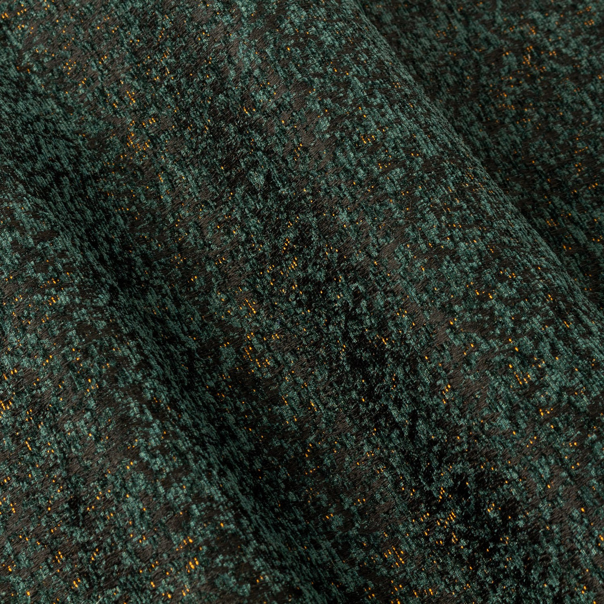 Close-up of Galaxy Chenille Fully Lined Eyelet Curtains in emerald, showing draped folds with fine golden flecks across the dense chenille pile.