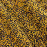 Close-up of Galaxy eyelet curtain fabric in gold, showing yarn-dyed chenille with a mottled, textured pattern over a dark base and soft folds.