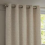 Galaxy Chenille Fully Lined Eyelet Curtains in ivory, textured woven fabric with silver eyelets on a brushed metal pole, shown against a window in a living room setting.