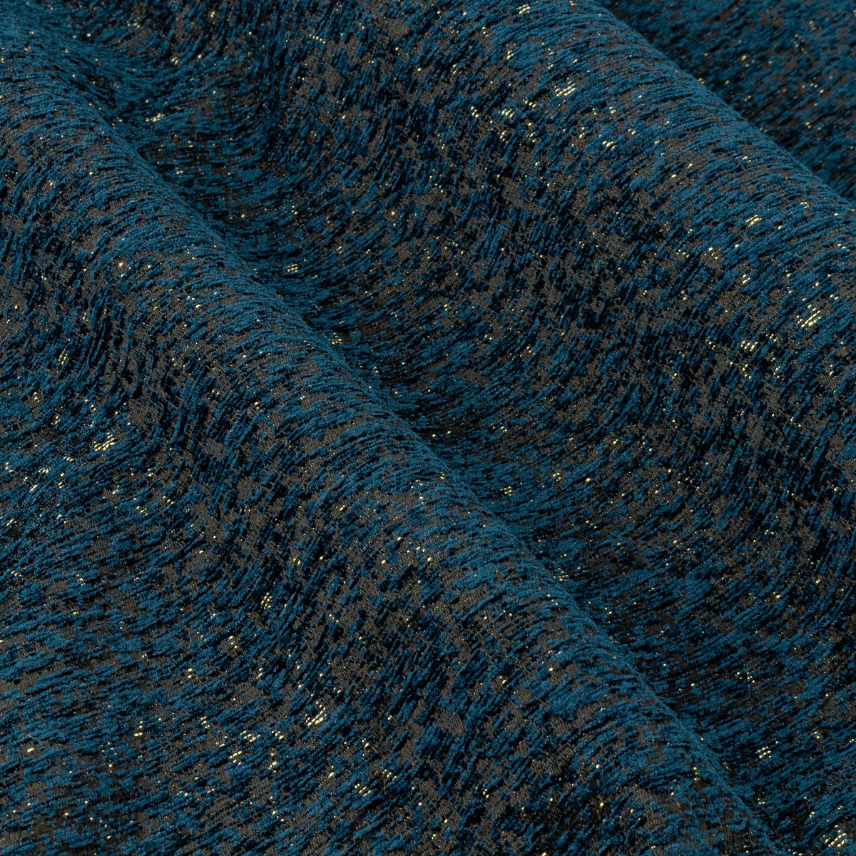 Close-up of Galaxy Chenille Fully Lined Eyelet Curtains in navy, showing folded chenille fabric with a mottled texture and fine gold metallic flecks.