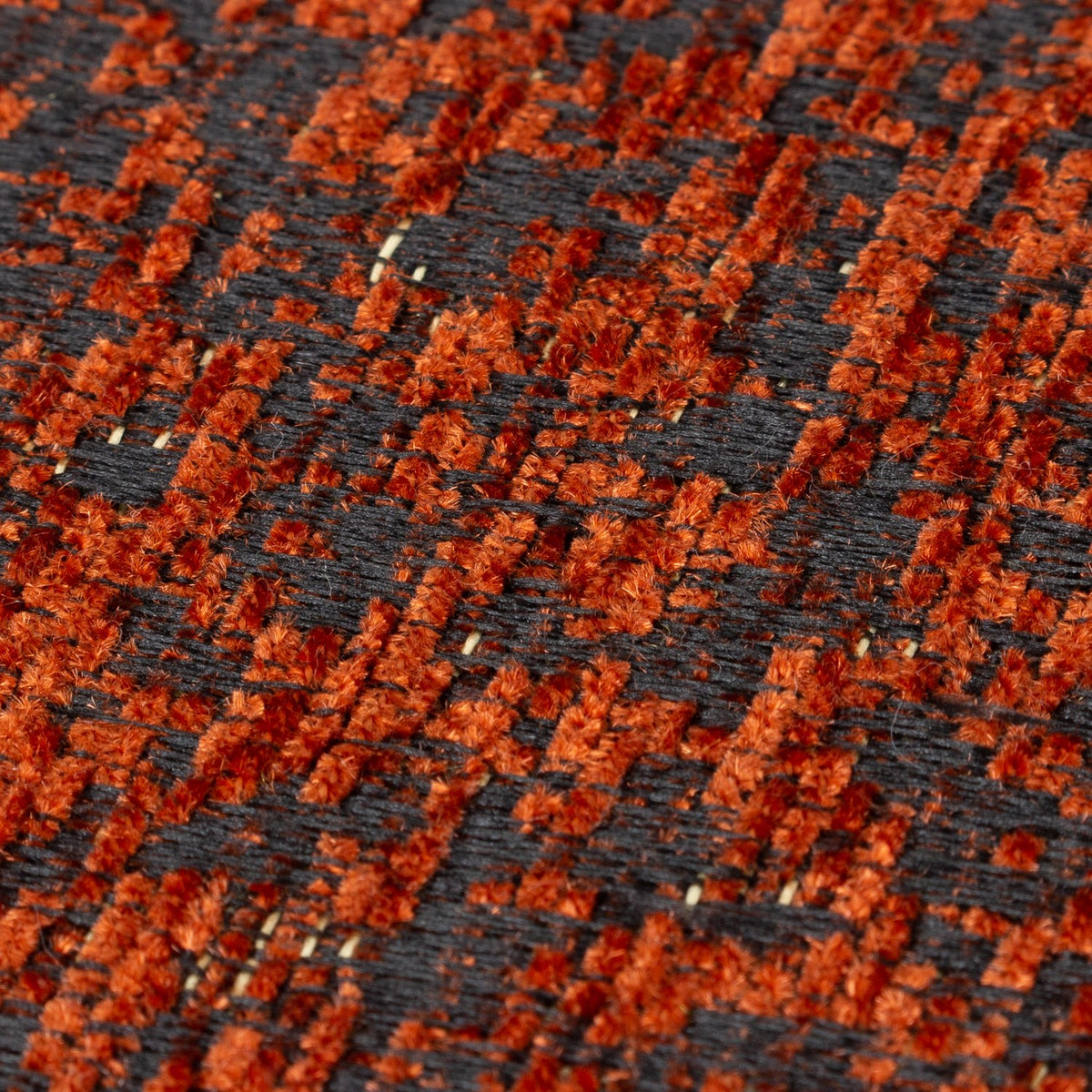 Close-up of the Galaxy Eyelet Chenille Cushion in copper, showing a dark woven base flecked with rust-orange textured chenille fibres.