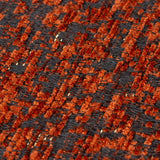 Close-up of the Galaxy Eyelet Chenille Cushion in copper, showing a dark woven base flecked with rust-orange textured chenille fibres.