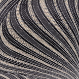 Gatsby Eyelet Polyester Cushion in black, close-up of woven Art Nouveau swirl pattern in natural tone on a black fabric ground.