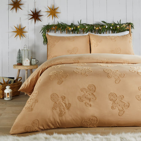 Ginger-tone duvet cover set with tufted gingerbread man design, styled on a bed with matching pillowcases in a festive bedroom with hanging star decorations.