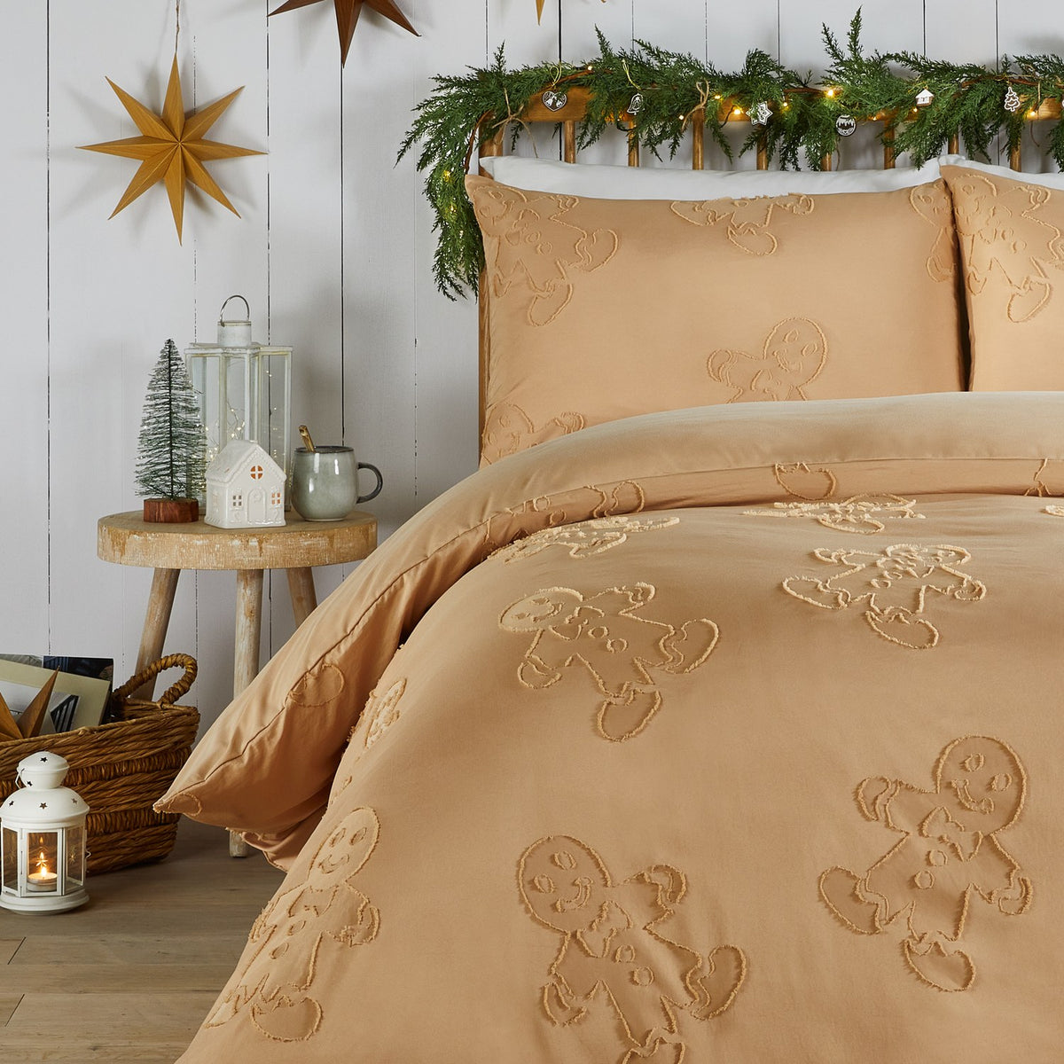 Ginger duvet cover set with tufted gingerbread figures in raised pile on a plain fabric ground, shown on a bed with matching pillowcases in a festive bedroom setting.