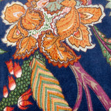 Georgia velvet cotton cushion in royal blue, close-up of the bold orange, russet and green botanical print against the deep blue ground.