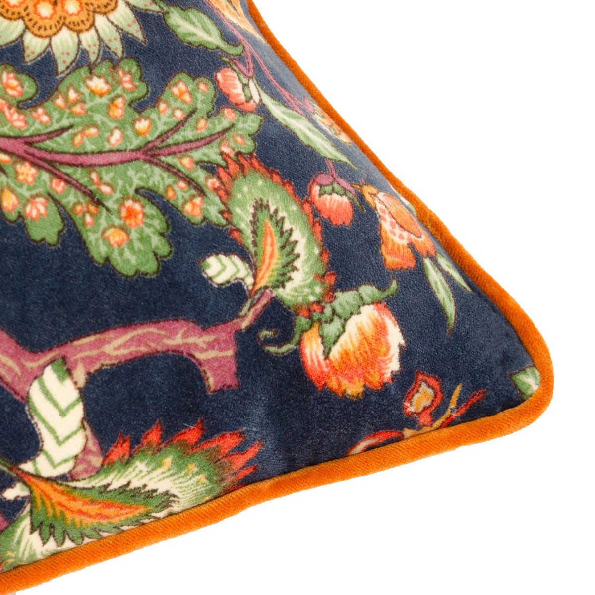 Corner detail of the Georgia Velvet Cotton Cushion in royal blue, showing the botanical floral print in orange, russet and green with contrast orange piped edge.
