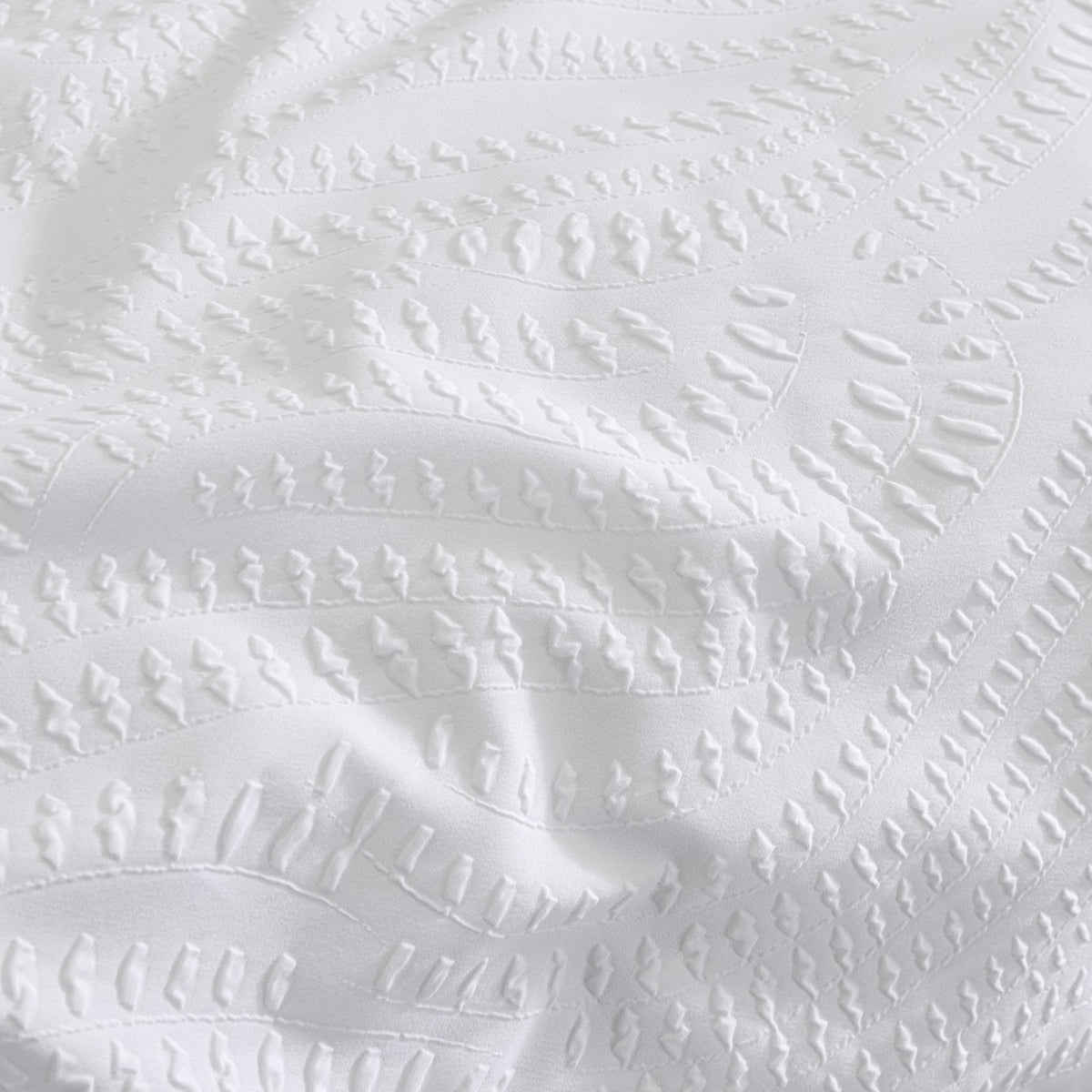 Close-up of the Georgia Woven Polycotton Duvet Cover in white, showing a raised heat-pressed textured pattern in wavy striped rows across the fabric surface.