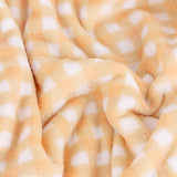Gingham Check Polyester Throw in yellow, close-up of plush short-pile fleece with a pale yellow and white checked pattern, softly draped in folds.