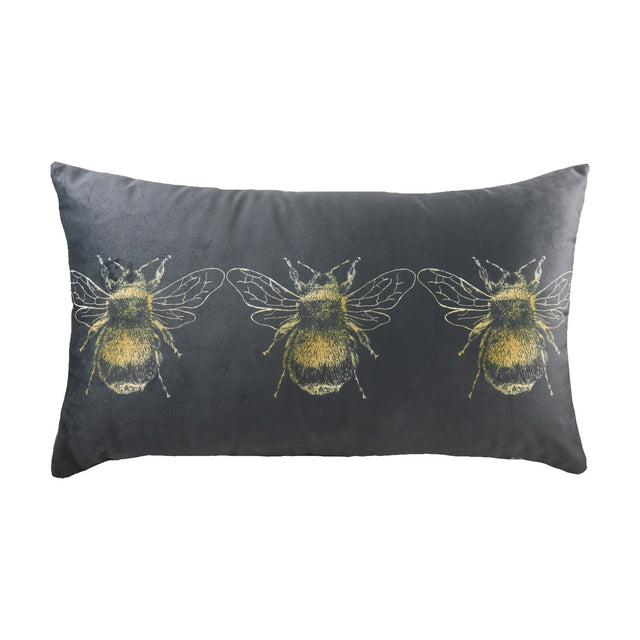 Rectangular grey velvet-effect cushion with three gold printed bee motifs in a row across the front, plain grey reverse, shown on a white background.