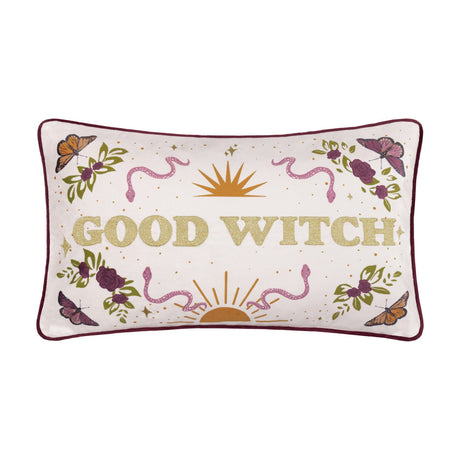 Rectangular velvet cushion in cream with gold-embroidered "Good Witch" lettering, bordered by roses, leaves, butterflies, snakes and a sun motif, burgundy piping, shown on a white background.