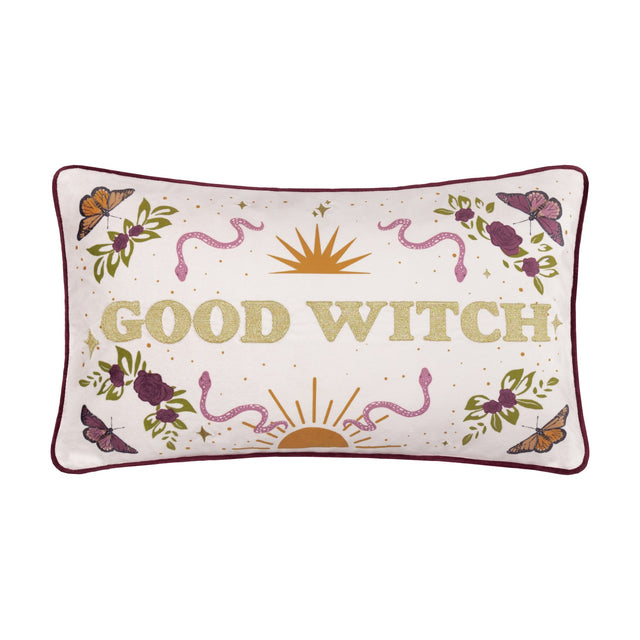 Rectangular velvet cushion in cream with gold-embroidered "Good Witch" lettering, bordered by roses, leaves, butterflies, snakes and a sun motif, burgundy piping, shown on a white background.