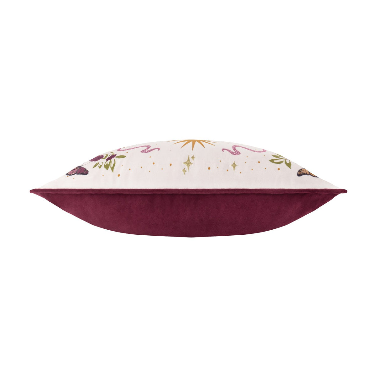 Side view of the Good Witch rectangular velvet cushion, showing cream front with embroidered gold lettering, botanical and snake motifs, and plain burgundy velvet reverse, on a white background.
