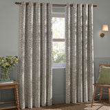Grace Leaf Jacquard Fully Lined Eyelet Curtains in mist grey, shown as a pair on a wooden pole in a living room, with woven leaf pattern and grommet top.