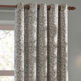 Grace Leaf Jacquard Fully Lined Eyelet Curtains in Mist Grey, hung on a wooden pole with metal eyelets, showing a woven leaf pattern in grey on a pale ground beside a window.