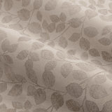 Close-up of Grace Leaf Jacquard Eyelet Curtains in taupe, showing the woven trailing leaf pattern in matt satin fabric with soft folds.