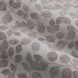 Close-up of Grace Leaf Jacquard pencil pleat curtain fabric in mist grey polyester, showing a woven trailing leaf pattern with a soft matt satin finish.