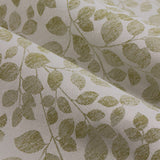 Close-up of Grace Leaf pencil pleat curtains in sage, showing a jacquard-woven trailing leaf pattern in green on a cream polyester ground with a soft fold.