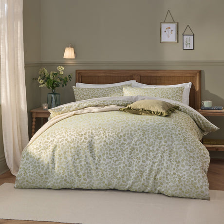 Grace Leaf Jacquard Floral Duvet Cover Set in sage, styled on a bed with matching pillowcases and a leaf-patterned jacquard design in a wood-panelled bedroom.
