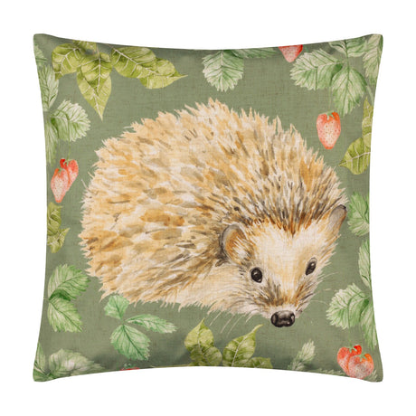 Square olive green polyester cushion featuring a hand-painted hedgehog design surrounded by strawberries and leaves, shown on a plain white background.