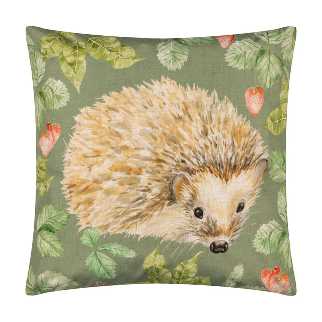 Square olive green polyester cushion featuring a hand-painted hedgehog design surrounded by strawberries and leaves, shown on a plain white background.