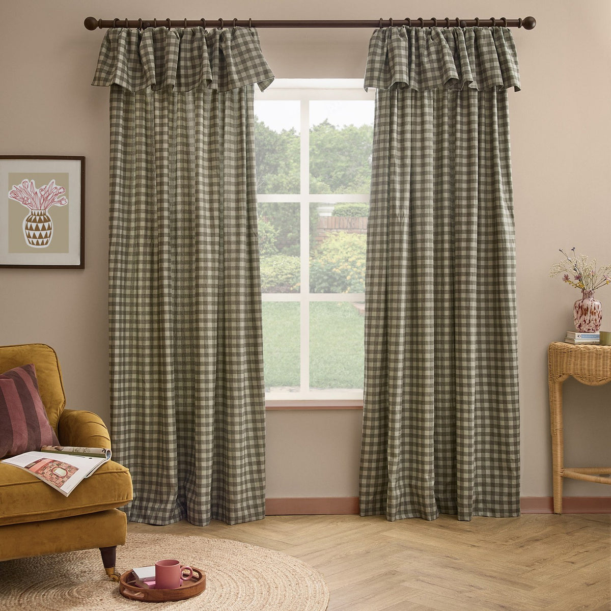 Harriet Gingham cotton pencil pleat curtains in bay green and mist check with ruffled header, hung on a pole in a living room beside a window.