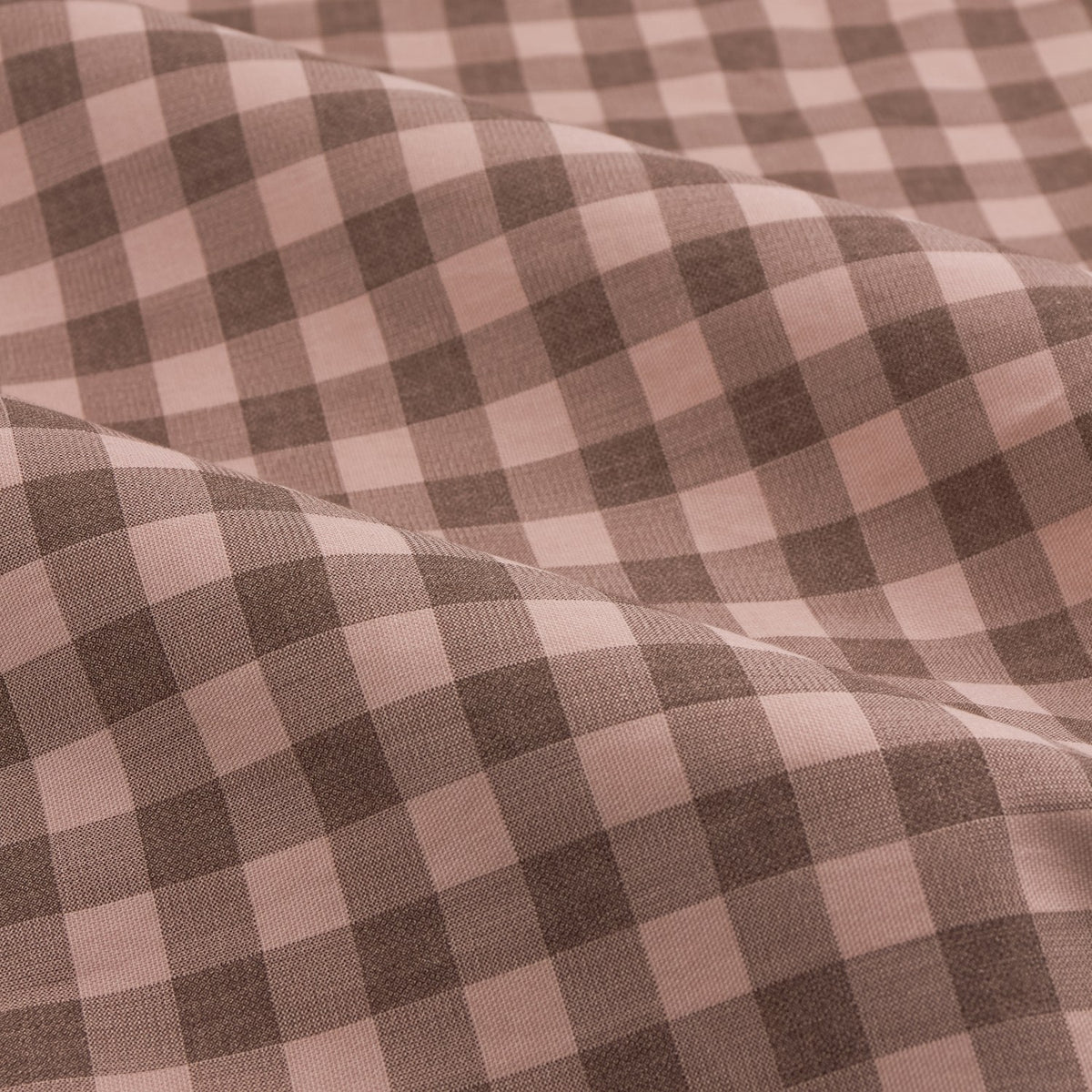Close-up of Harriet Gingham Cotton Pencil Pleat Curtains fabric, showing a rose pink and chocolate brown check pattern in draped folds.