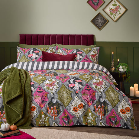 Hallowquin Reversible Striped Duvet Cover Set in multicolour on a bed with striped reverse, styled in a green bedroom with velvet headboard, cushions and throws.