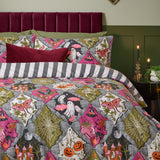 Reversible Halloween duvet cover set with matching pillowcases, printed with ghosts, pumpkins, skeletons and cobwebs in pink, olive and grey diamond panels, reversing to grey and white stripes.