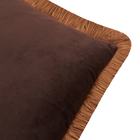 Close-up of the Halo Fringed Velvet Cushion showing a chocolate brown velvet square face bordered by a caramel fringed trim, on a plain white background.