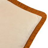 Close-up of the Halo Fringed Velvet Cushion showing its plain ecru velvet face bordered by a dense ginger-orange fringed trim, set against a plain white background.