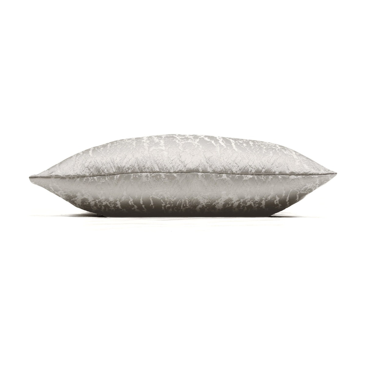 Side view of the Hamlet Printed Polyester Cushion in alabaster, showing a rectangular shape with a shimmering marbled metallic print on cream fabric, set against a plain white background.