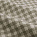 Close-up of Harriet Gingham cotton pencil pleat curtain fabric, showing a sage-grey and cream checked pattern in soft draped folds.