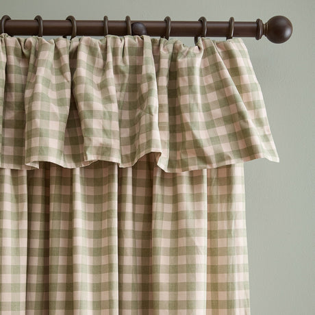 Harriet Gingham Cotton Pencil Pleat Curtains in pink and green check, showing a ruffled frill header on a dark wood curtain pole against a light wall.