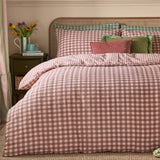 Harriet Gingham Cotton Check Duvet Cover Set in Rose/Chocolate, shown styled on a bed with matching pillowcase, seersucker check pattern, and green and pink accent cushions in a bedroom setting.