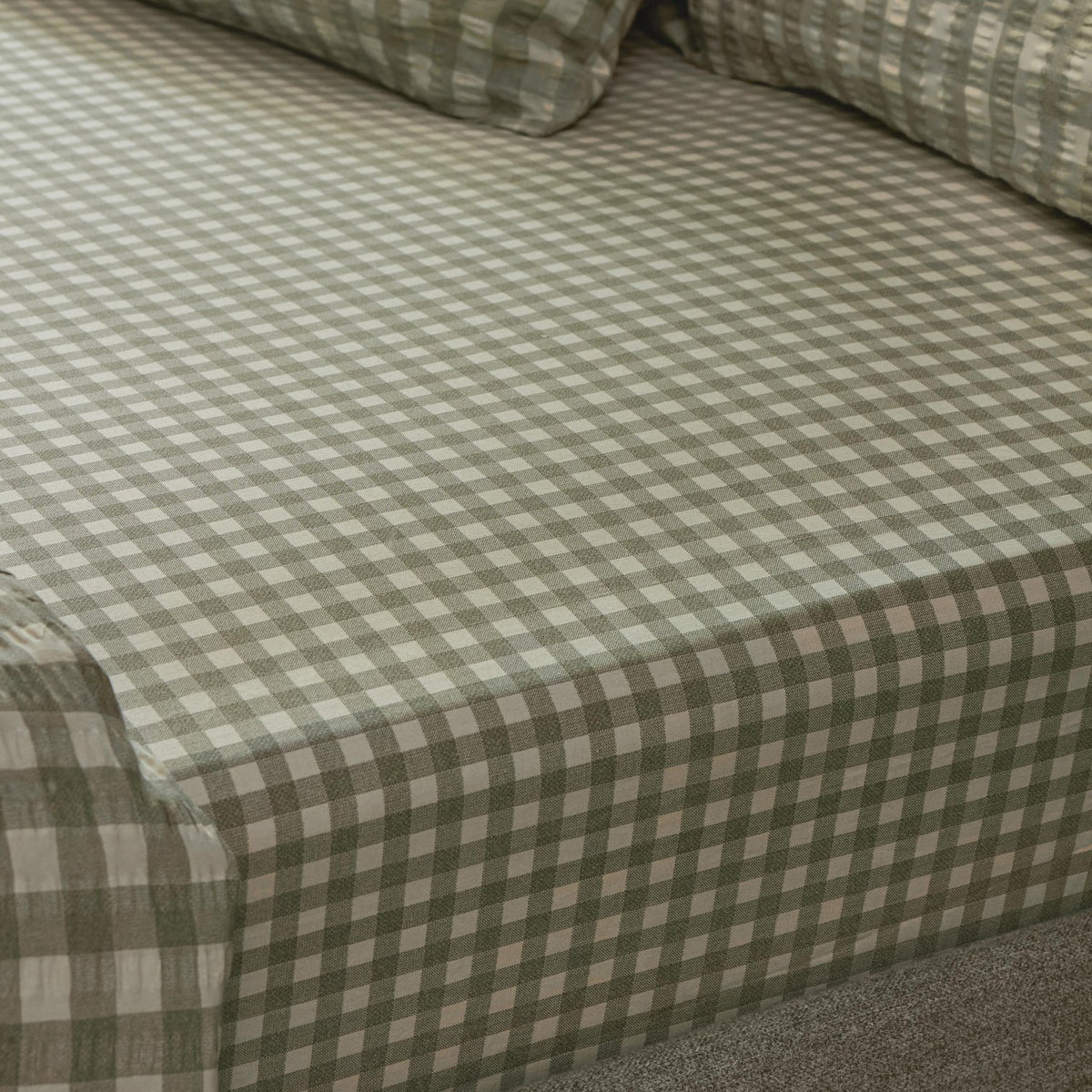 Harriet Gingham Check Cotton Fitted Sheet in Baygreen/Mist, showing the sage-and-cream check pattern and textured cotton weave fitted over a mattress corner.